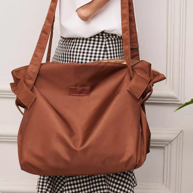Brown Oxford cloth shoulder messenger bag with top handle and front flap pocket