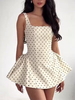 White polka dot mini dress with square neckline and wide, gathered flared skirt