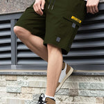 Men's olive utility shorts with drawstring, high waist, and flap cargo pockets
