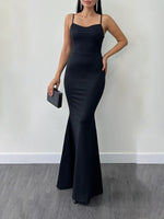 Halter-style suspender dress in dark navy with thin spaghetti straps and fitted mermaid hem