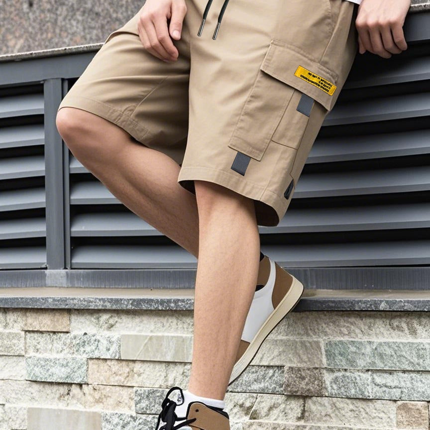 Men's beige utility shorts with drawstring, high waist, and flap cargo pockets