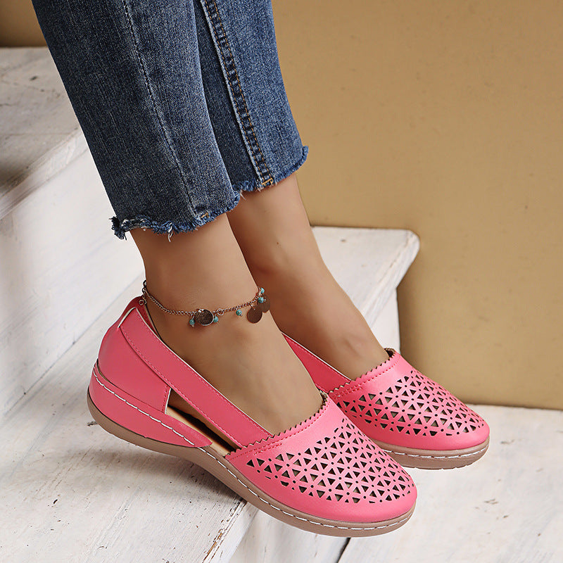 Fuchsia pink round-toe wedge sandals with laser-cut upper and ankle strap