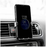 Car air vent phone holder gripping a smartphone with side clamps and cradle pad