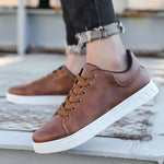 Brown lace-up flat casual shoe with round toe, brown laces, and white textured sole