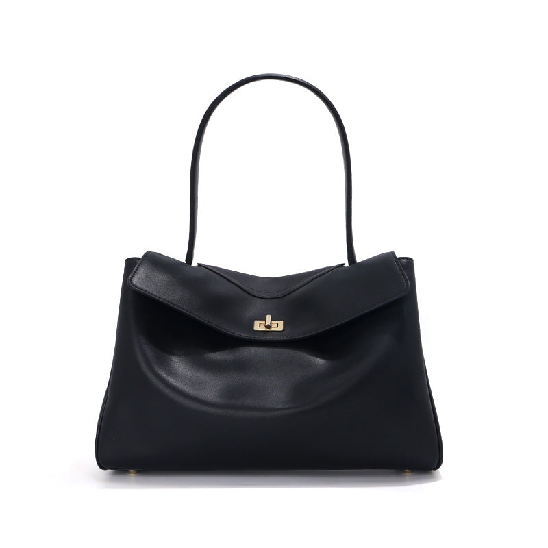 Black leather tote bag front view with curved handle and gold-tone clasp