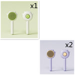 Pet grooming massage comb set with green and purple round bristle brushes on white handles