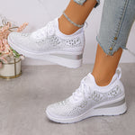 Women's white rhinestone lace-up wedge sneakers with textured mesh upper and white sole.