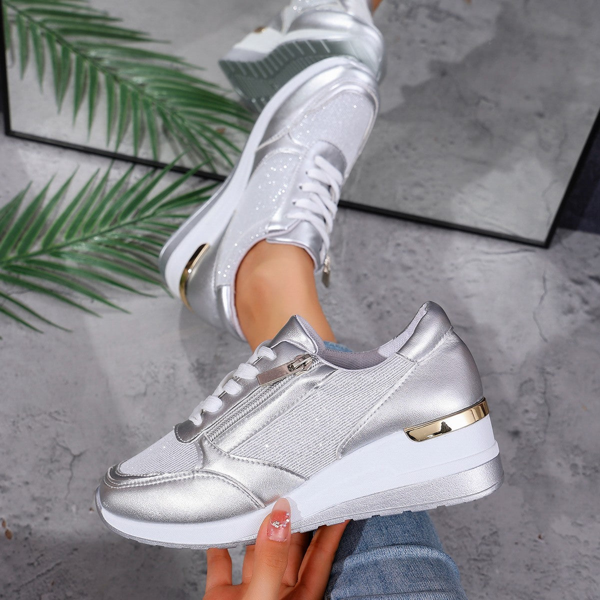 Women's silver lace-up sneakers with side zip and metallic gold heel detail