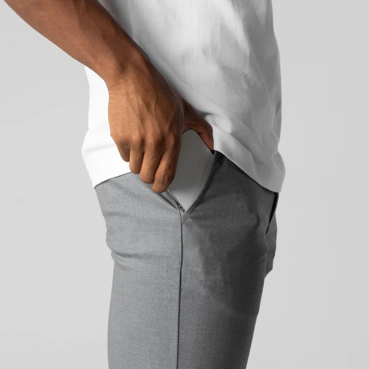 Gray slim-fit trousers waistband and front pocket view, button closure, straight legs