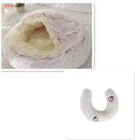 Half-moon plush bolster with light gray fabric and small face/heart patches