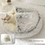 Round plush pet bed with cave opening; gray fuzzy exterior with cream inner cushion