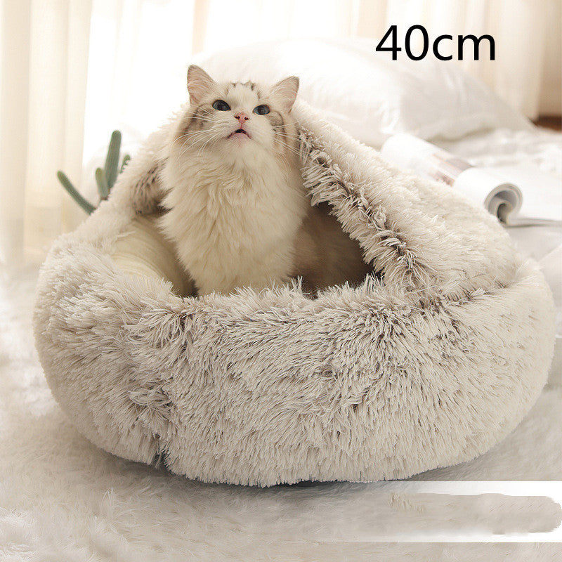 Light grey round plush pet bed with long shag rim, cat curled up inside.