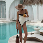 Color-block one-piece swimsuit with black V-neck and white panels, slim straps