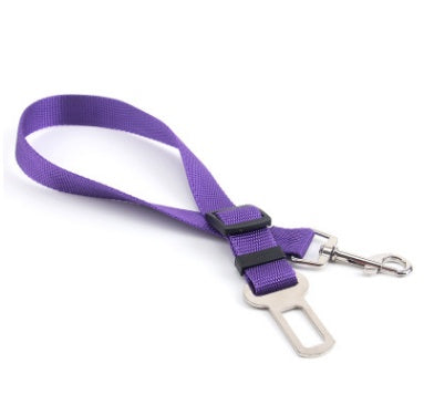 Adjustable dog car seat belt strap in purple with metal clips and buckle adjuster.