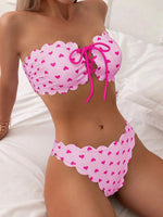 Pink printed tube-top bikini with magenta hearts, tie-front drawstring, scalloped high-waist briefs