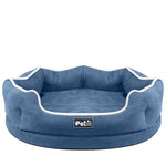 Blue round removable pet bed mattress with white piping and logo patch, centered