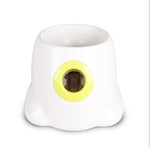 White dog ball launcher with lime-green ring opening for tennis balls