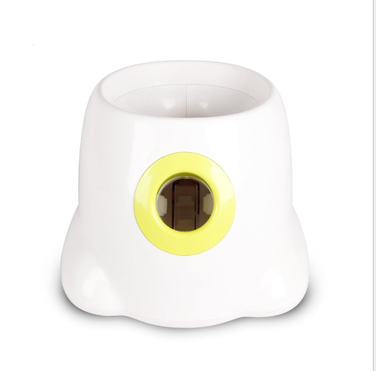 White dog ball launcher with lime-green ring opening for tennis balls
