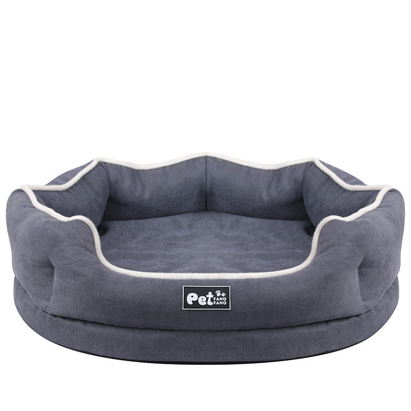 Blue round pet bed mattress with white piping and logo patch, front view