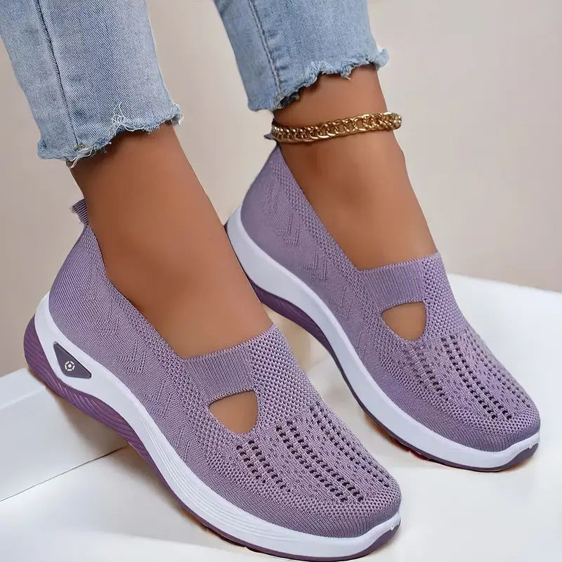 Women's mesh slip-on flats in lavender, cutout toe and white sole.