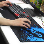 Black desk mat with blue dragon design and smooth tracking surface