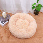 Round shaggy pet sleep bed in apricot, with cushioned ring and inner recessed area