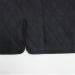 Black quilted pet car mat corner with stitched edge and textured fabric
