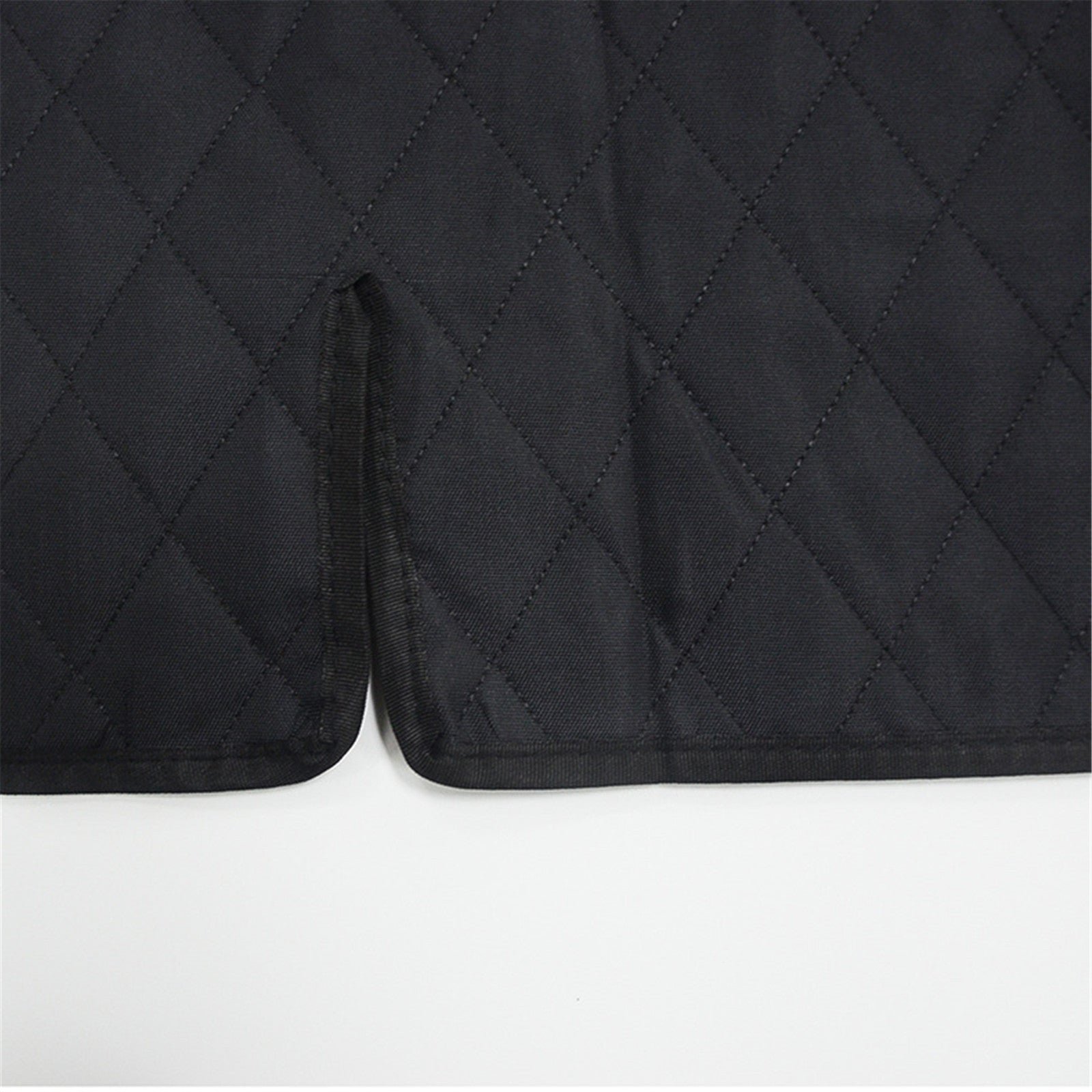 Black quilted pet car mat corner with stitched edge and textured fabric