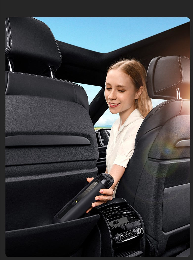 Handheld wireless car vacuum cleaner being used on a car seat in dark finish