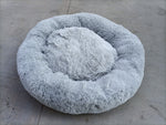 Round shaggy pet sleep bed in light grey, with plush rim and inner lounging bowl