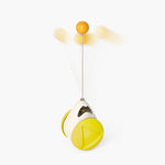 Cat rotating windmill toy with yellow ball and white cord, hanging on oval housing