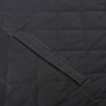 Black dog car seat cover close-up of quilted panels and folded seam edge