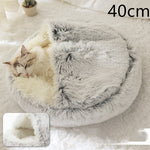 Grey round plush pet bed with shag lining, cat curled up inside.