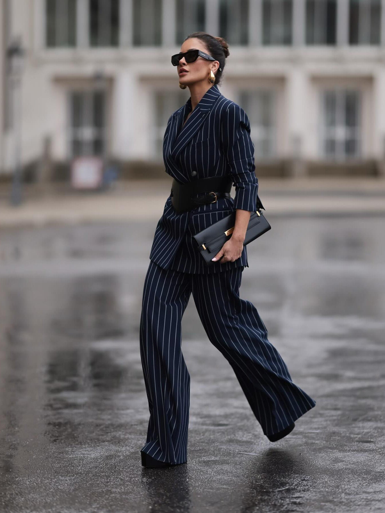 Navy pinstripe blazer and high-waist wide-leg pants with black belt, side view