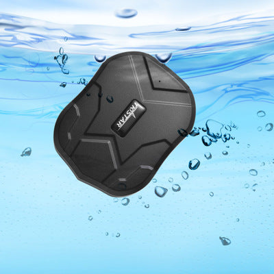 Waterproof black KSTSTAR GPS tracker on wet surface with water droplets