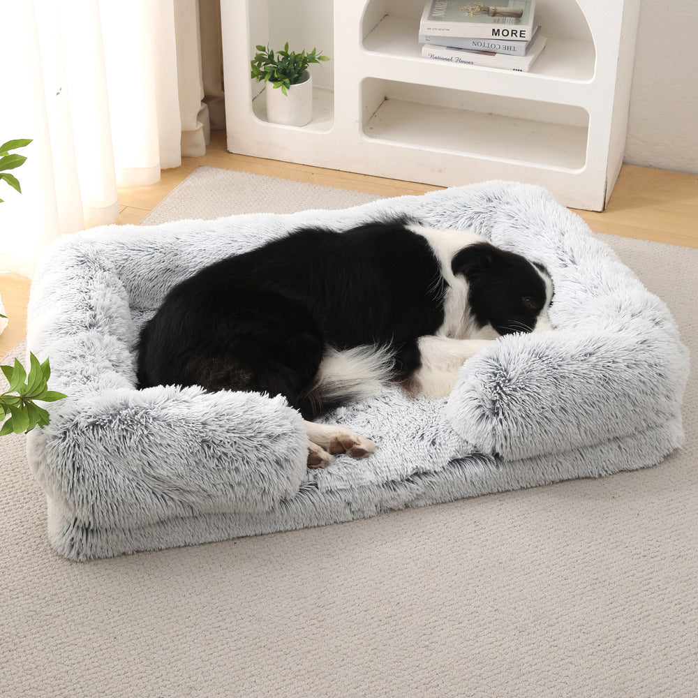 Light gray plush dog bed with rounded bolsters and cushioned base
