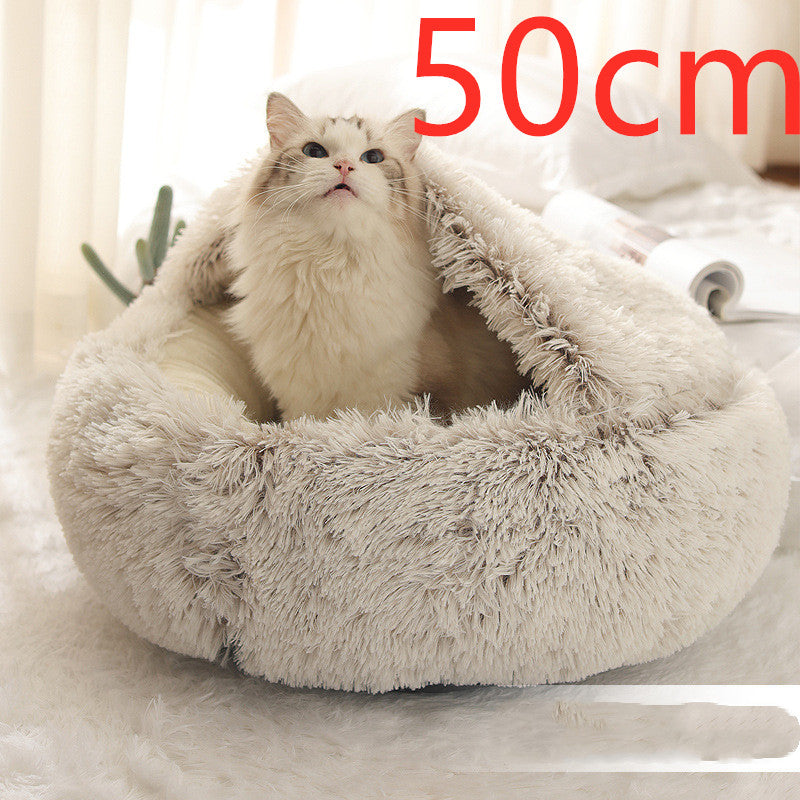 Light grey round plush pet bed with shag rim, cat sitting inside.