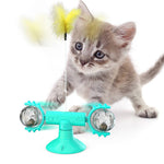 Teal windmill cat toy with clear side spheres and a yellow fuzzy cat feather
