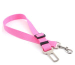 Adjustable dog car seat belt strap in pink with metal clips and buckle adjuster.