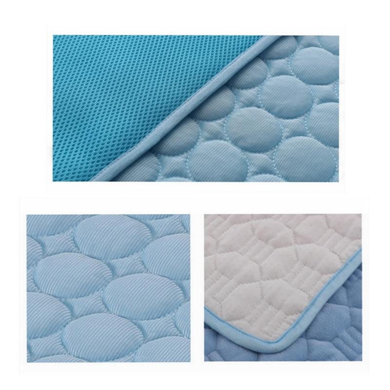 Blue cooling pad fabric close-up with round pebble quilting and stitched edge
