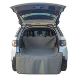 Grey waterproof pet trunk mat covering cargo area with quilted back panel
