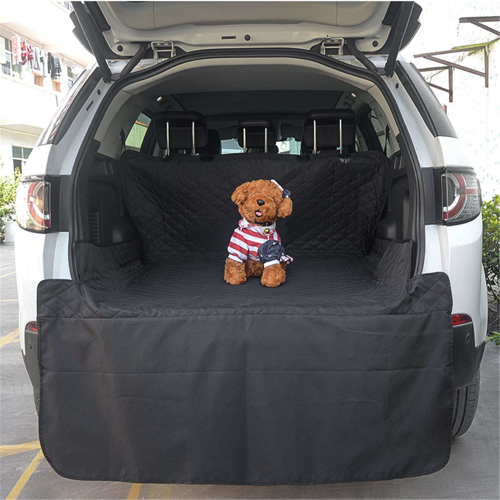 Black quilted pet trunk mat with dog toy centered on the cargo cover