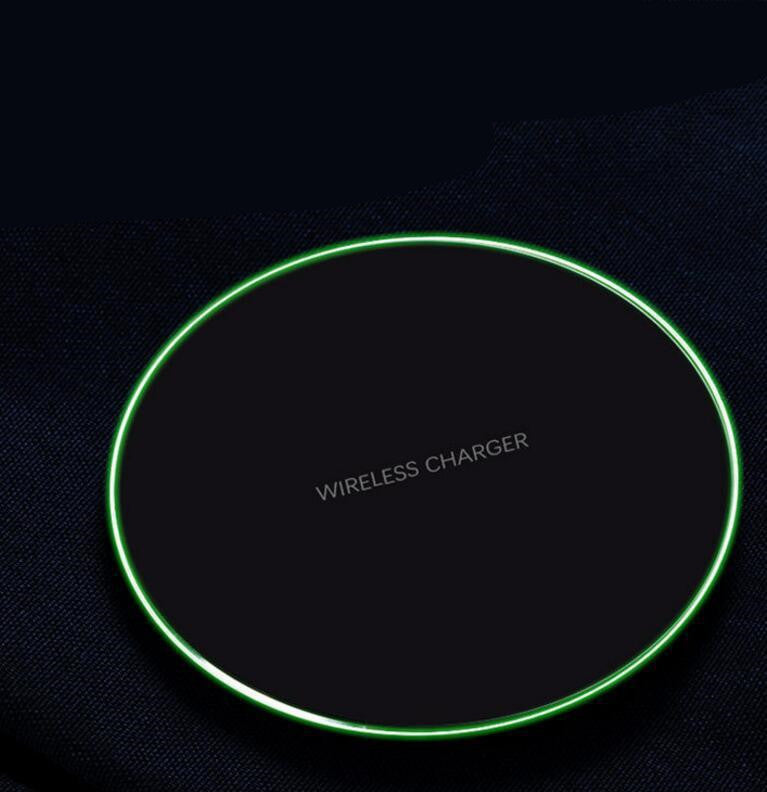 Black wireless charging pad with bright green outer LED ring, top view