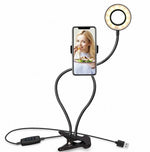 LED selfie ring light with warm glow, smartphone holder, and adjustable clip base
