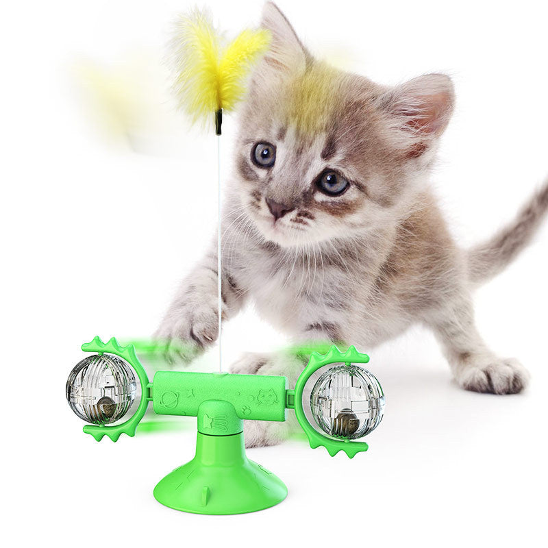 Green windmill cat toy with clear side spheres and a yellow fuzzy cat feather