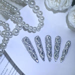 Long almond silver crystal press-on nails with oval jeweled center rhinestone details