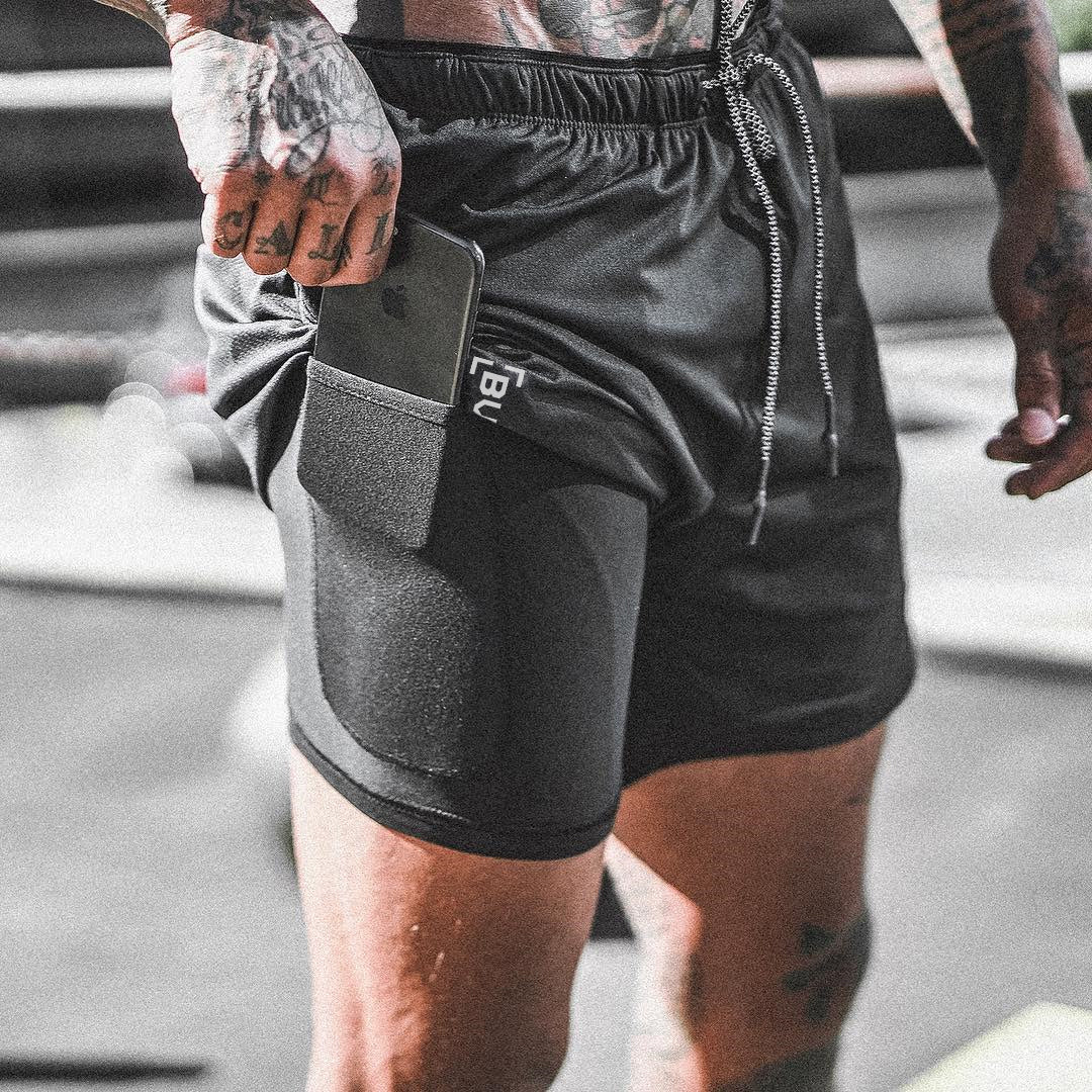 Black pocket compression shorts with side phone holder and elastic waistband