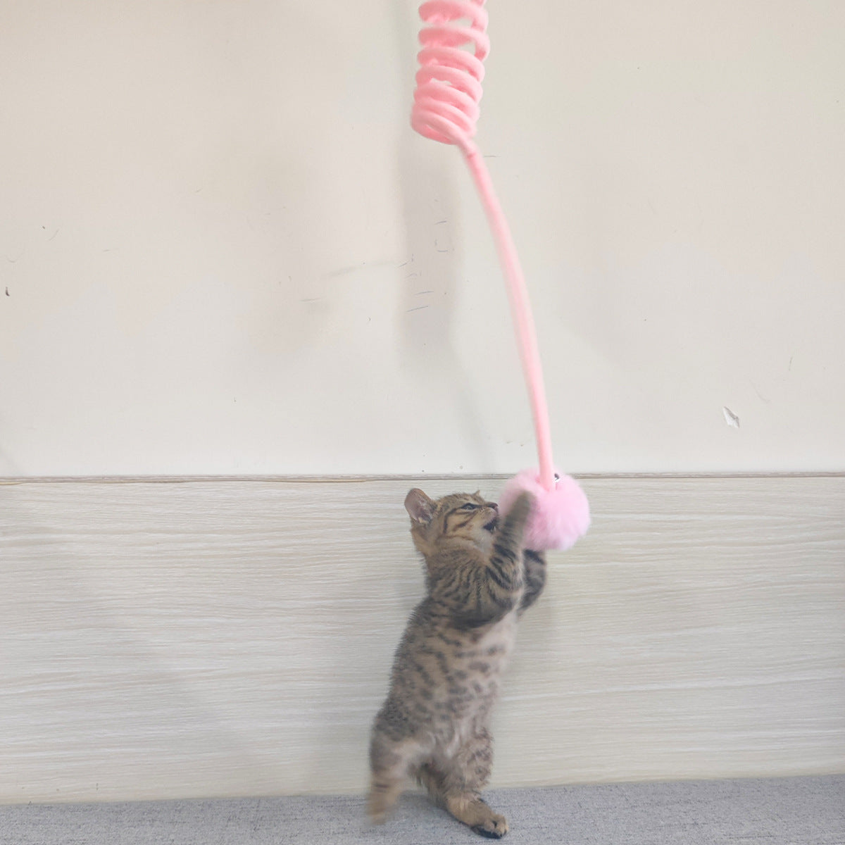 Cat spring toy wand with pink coil and fluffy pink pom ball