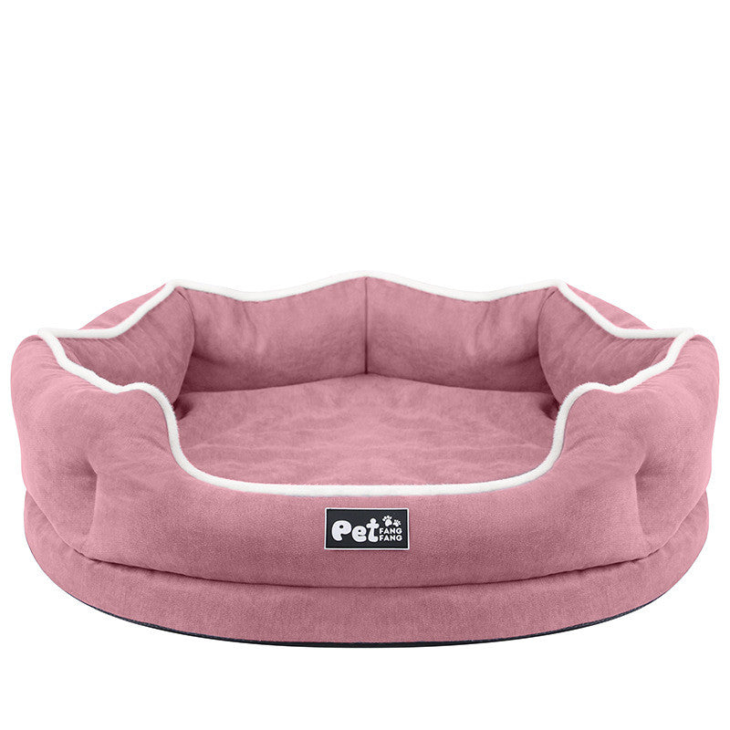 Pink round removable pet bed mattress with white piping and logo patch on front
