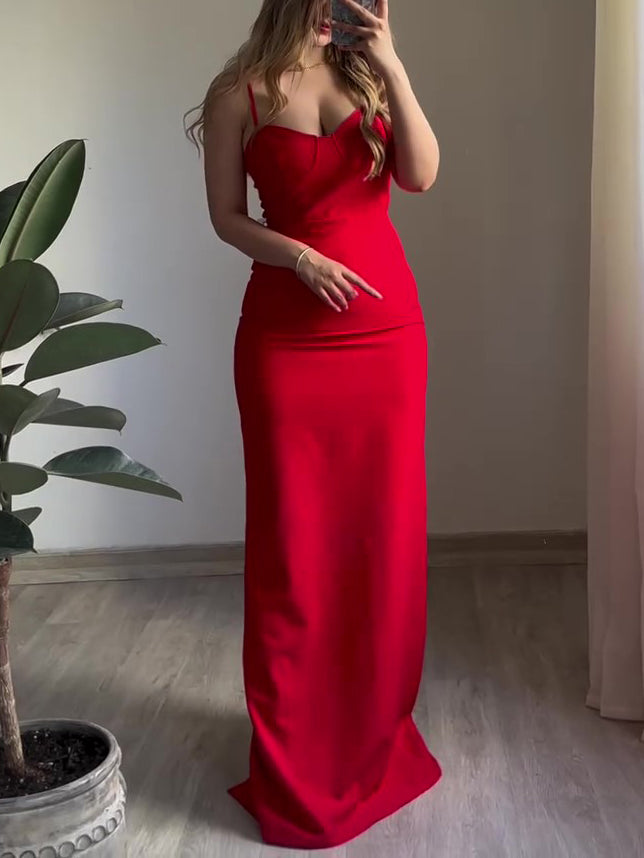 Red satin maxi slip dress with spaghetti straps and front slit, fitted silhouette.